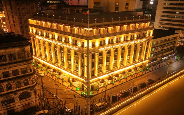 The Juan Luna Building emits a warm glow at night